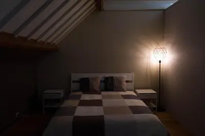 a bedroom with a bed and a lamp in it at Glabbeek-hoeve in Geetbets