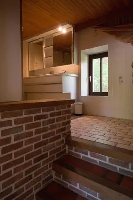 an empty room with a brick wall and a window at Glabbeek-hoeve in Geetbets
