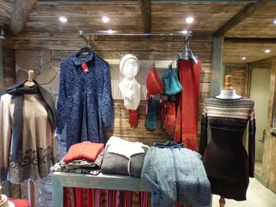a store with many different types of clothes on display at De Alpacaboerderij in Bocholt