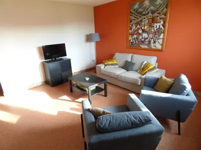 a living room with two couches and a tv at De Alpacaboerderij in Bocholt