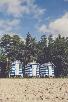 three blue and white homes sitting on a beach at Landhuisjes Bij De Wouterbron in Oudsbergen