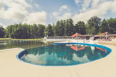 a large pool of water with a roller coaster at Landhuisjes Bij De Wouterbron in Oudsbergen