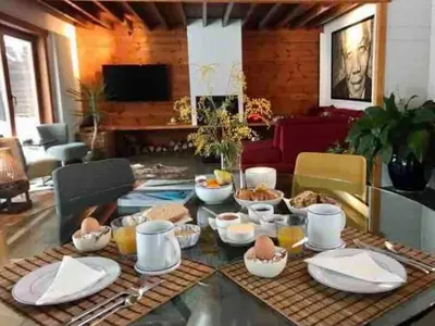a living room with a table with food on it at Nîdwazô - Ecolodge & Maison d'hôtes in Trooz
