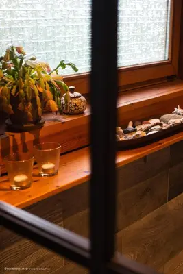 a table with some glasses and a plate of food at Nîdwazô - Ecolodge & Maison d'hôtes in Trooz