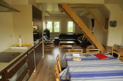 a room with a kitchen and a living room at Holiday Home Op 't Busselen in Opoeteren