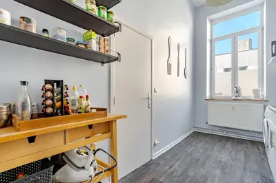 a kitchen with white walls and a counter and a window at Duplex 90m Centre Verviers Calme Gare à pied Spa Francorchamps 20 min in Verviers
