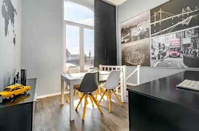 a dining room with a table and chairs and a yellow car at Duplex 90m Centre Verviers Calme Gare à pied Spa Francorchamps 20 min in Verviers