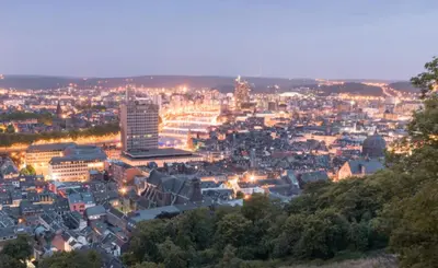a view of a city at night at SuiteDreams - Bubble Suite Liège in Liège
