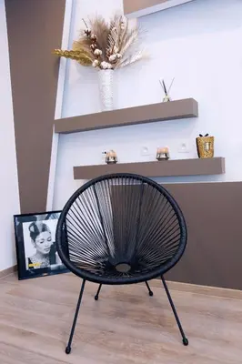 a black chair in a room with a picture at SuiteDreams - Bubble Suite Liège in Liège