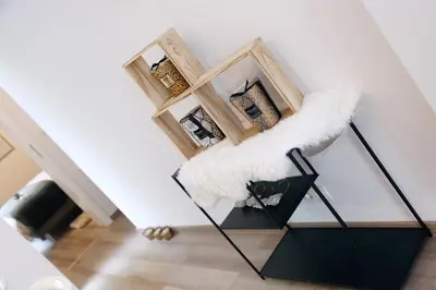 a room with a white wall and a black stand at SuiteDreams - Bubble Suite Liège in Liège
