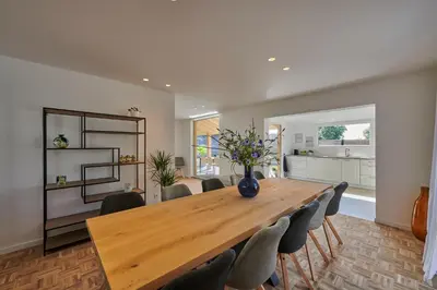 a dining room with a wooden table and chairs at Vakantiehuis Sahara119 in Lommel