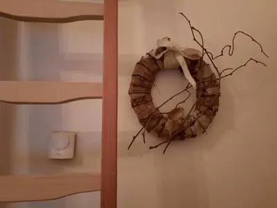 a wreath hanging on a wall next to a lightswitch at Hof van Eggertingen nr. 8 in Riemst