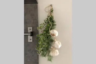 a bunch of garlic hanging on a wall at Hof van Eggertingen Bakhuis in Riemst