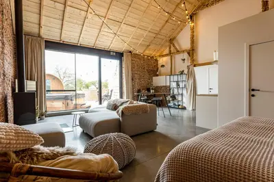 a living room with a couch and a table at De Hoeveschuur in Riemst