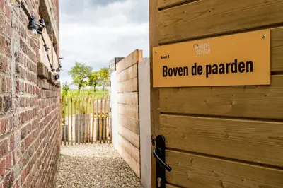 a garage door with a sign that reads bourbon de parlez at De Hoeveschuur in Riemst
