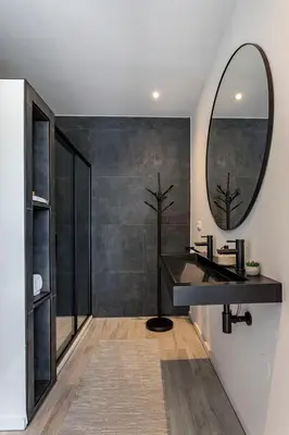 a bathroom with a black sink and a mirror at De Hoeveschuur in Riemst