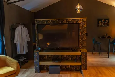 a living room with a large flat screen tv at Paradis Secret in Beyne-Heusay