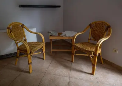 two chairs and a table in a room at Logement de Blauwe Reiger in Voeren