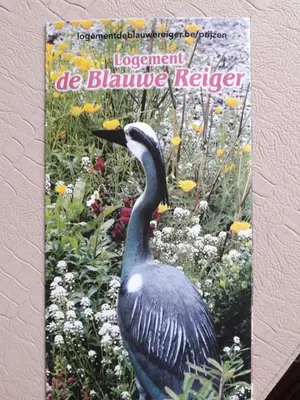 a book with a picture of a bird in a garden at Logement de Blauwe Reiger in Voeren