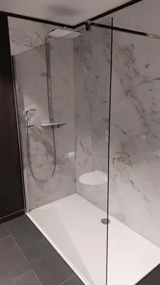 a shower with a glass door in a bathroom at Vinotel X in Tongeren