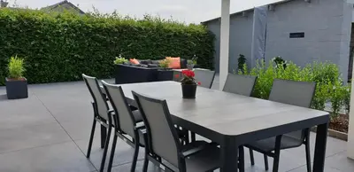 a wooden table and chairs on a patio at Prinsheerlyck in As