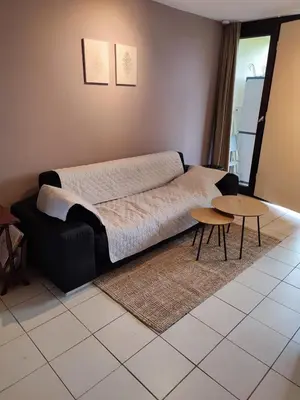 a bedroom with a bed and two tables in it at Your Stay in Kelmis - La Calamine- Cosy apartment in the Ardennes -Three-country point - Neu-Moresnet in Kelmis