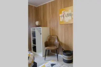 a room with a chair and a white cabinet at 'T ONDERDAK in Lommel