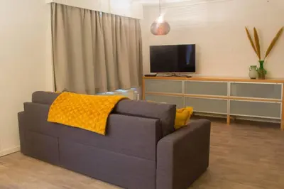 a living room with a couch and a tv at 'T ONDERDAK in Lommel
