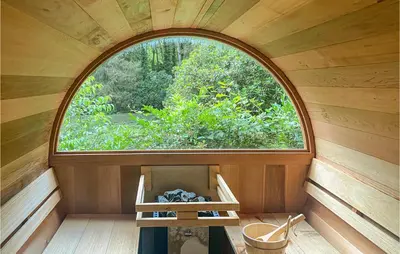 an arched window in a wooden room with a table at Stunning Home In Meeuwen-Gruitrode in Aan ʼt Hoolven