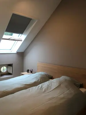 a bedroom with two beds and a skylight at Factorij10 in Peer