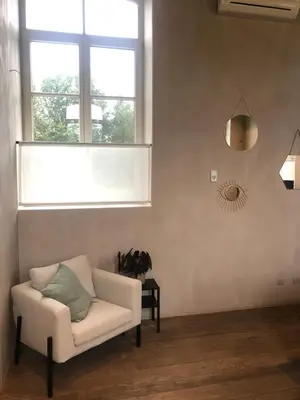 a living room with a chair and a window at Factorij10 in Peer
