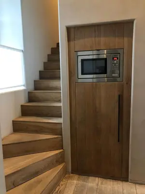 a door with a microwave on it next to a staircase at Factorij10 in Peer