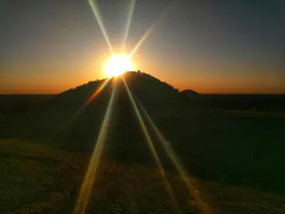 a sun setting on top of a hill at B&B La Miniera in Genk