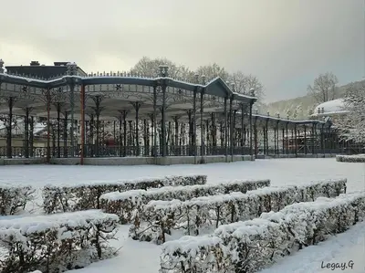 a garden covered in snow with a gazebo at Le Petit Logis in Jalhay