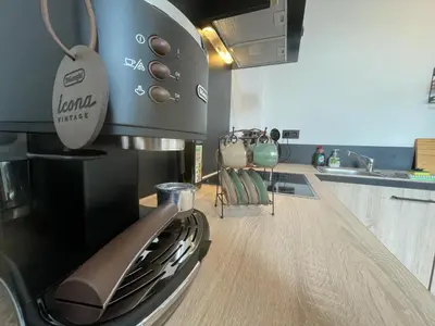 a kitchen with a coffee maker on top of a stove at Patenier Hidden Garden 1bdr with garden in Liège