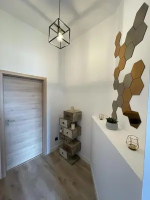 a room with a hallway with a door and wooden floors at Patenier Hidden Garden 1bdr with garden in Liège