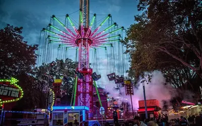 a ferris wheel at a carnival at night at La cave de Nana in Liège