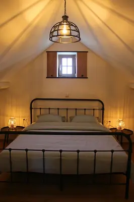 a bedroom with a bed and a window at Het Koerhuis in Kinrooi