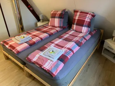 a bed with two towels and two pillows on it at La Casita E41 in Lanaken