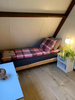 a bed in the middle of a room at La Casita E41 in Lanaken