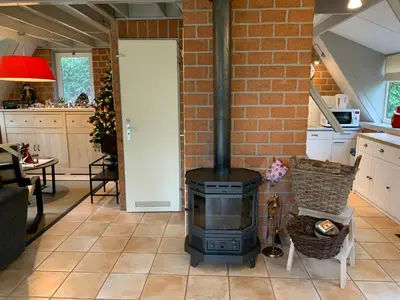a fireplace in a kitchen with a brick wall at La Casita E41 in Lanaken