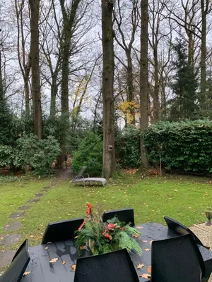 a table with flowers on it in a park at La Casita E41 in Lanaken