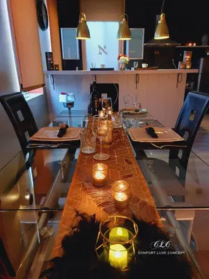 a long table with candles and lights on it at Le BELLEA in Verviers