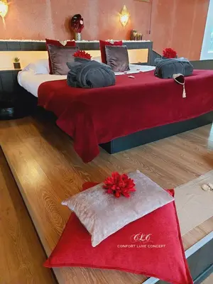 two beds in a room with a red blanket at Le BELLEA in Verviers