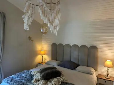 a bedroom with a large bed with two lamps at Chalet Maurice in Zutendaal
