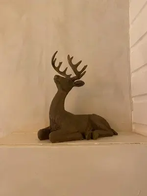 a statue of a reindeer sitting on a shelf at Chalet Maurice in Zutendaal