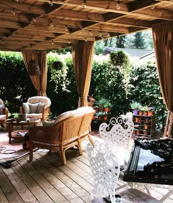 a patio with a bench and chairs on a deck at Chalet Maurice in Zutendaal