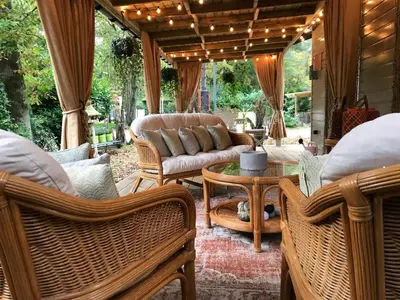 a patio with chairs and a couch and a table at Chalet Maurice in Zutendaal