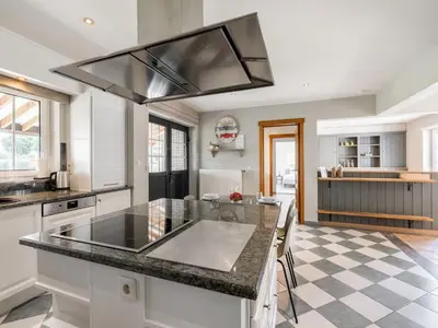 a kitchen with a large island with a counter top at Alken Farm Stay with Terrace in Alken