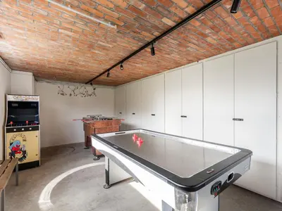 a ping pong table in a room with white cabinets at Alken Farm Stay with Terrace in Alken
